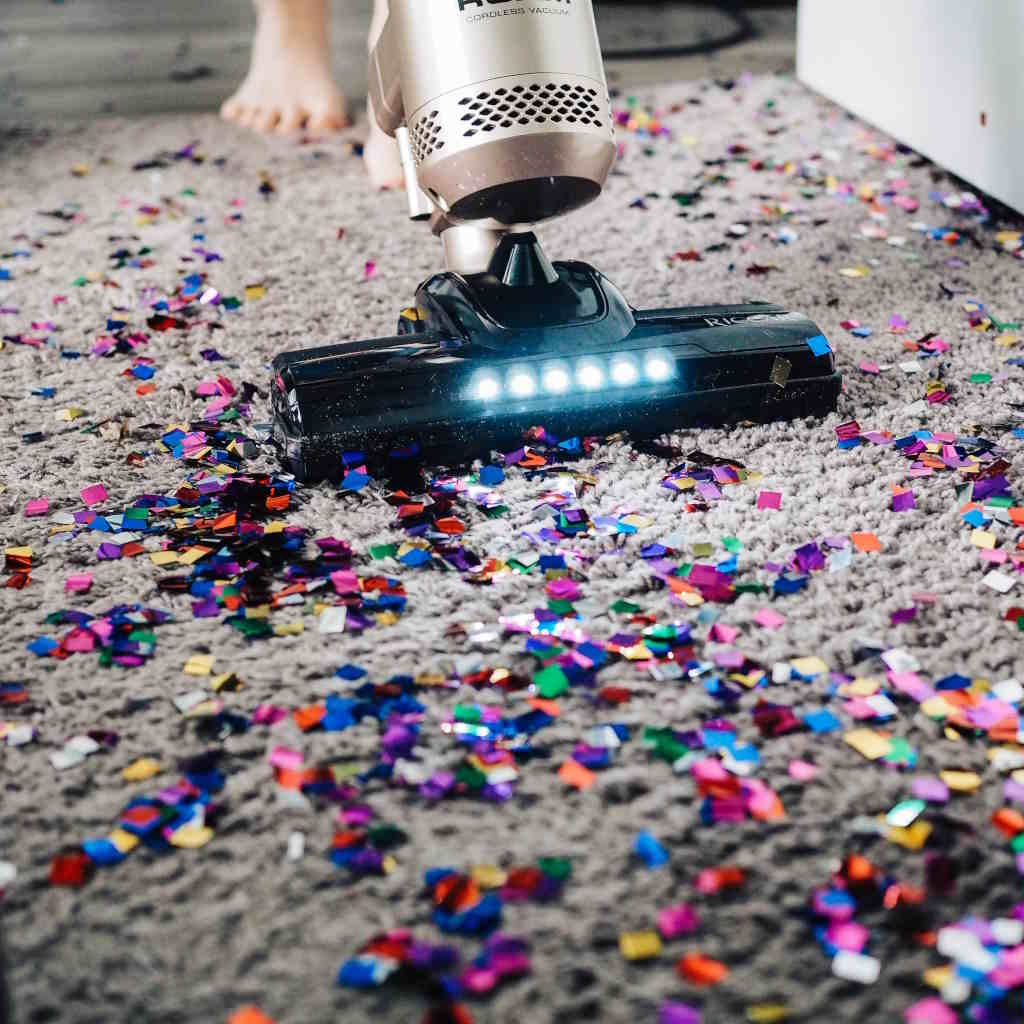 Best Robot Vacuum For Pet Hair - A Vacuum Cleaner On The Floor With Confetti | The List Of